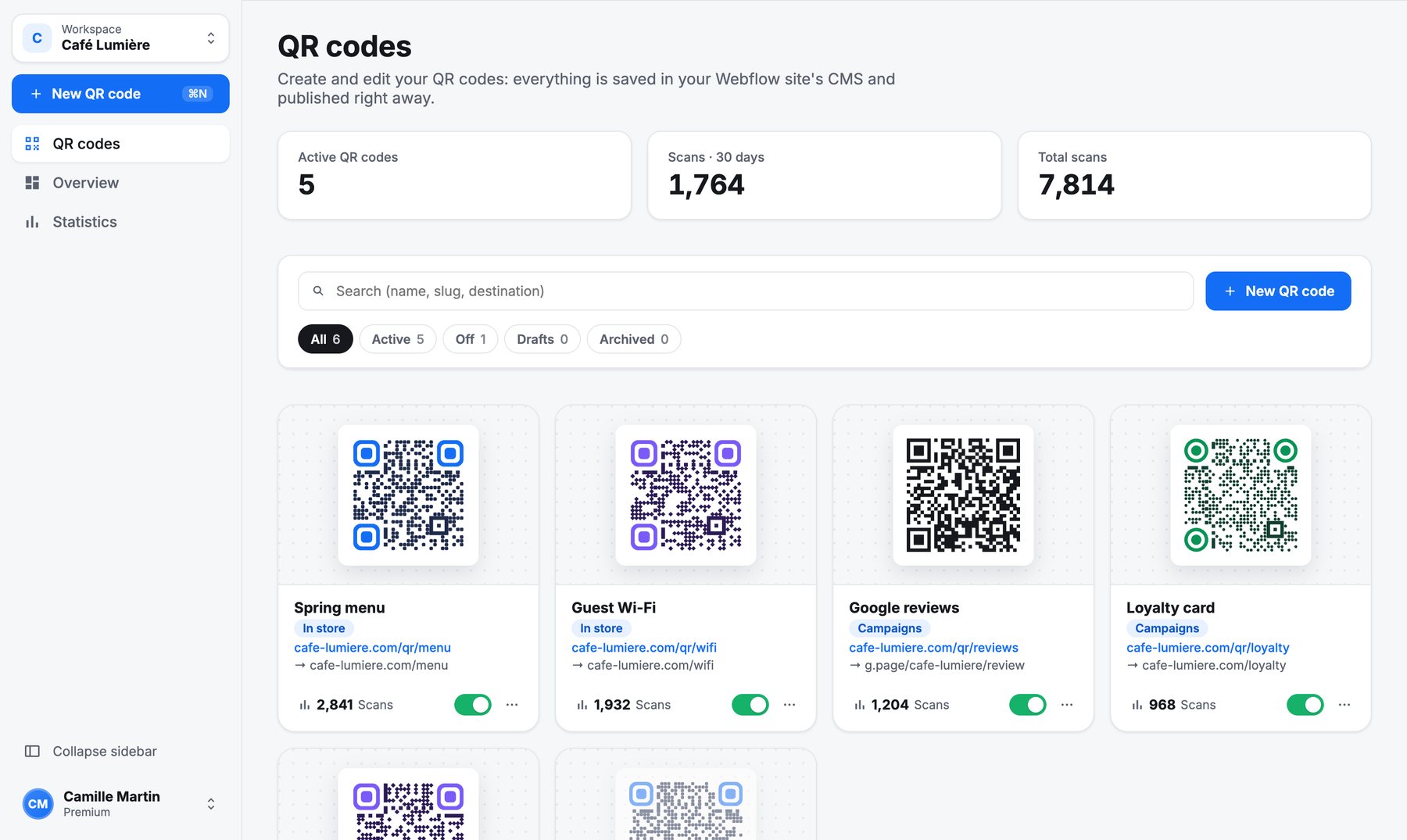 The QR Manager desktop app: workspace selector, New QR code button and QR code cards.